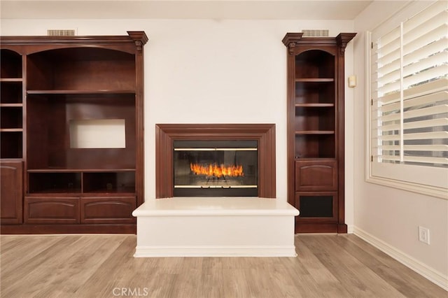 6471 Frampton Cir, Huntington Beach, CA 92648 - unfurnished living room featuring light wood finished floors and a glass covered fireplace