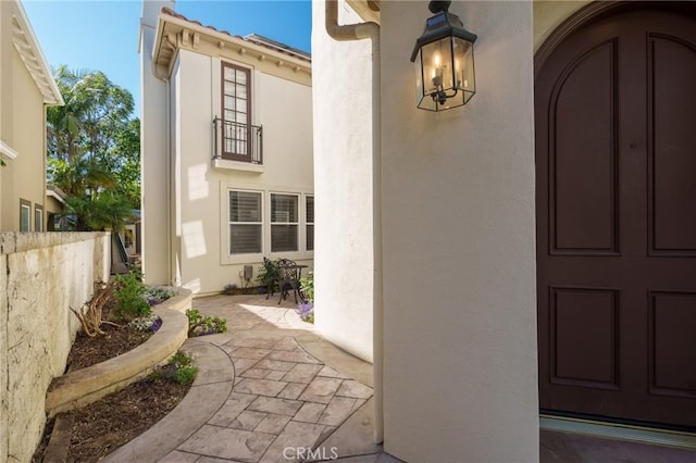 6471 Frampton Cir, Huntington Beach, CA 92648 - view of exterior entry with stucco siding and a patio