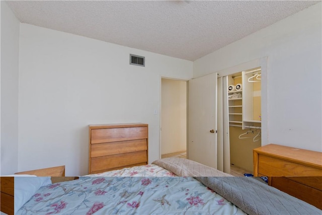 16751 Ludlow St, Granada Hills, CA 91344 - bedroom with a spacious closet, a textured ceiling, and a closet