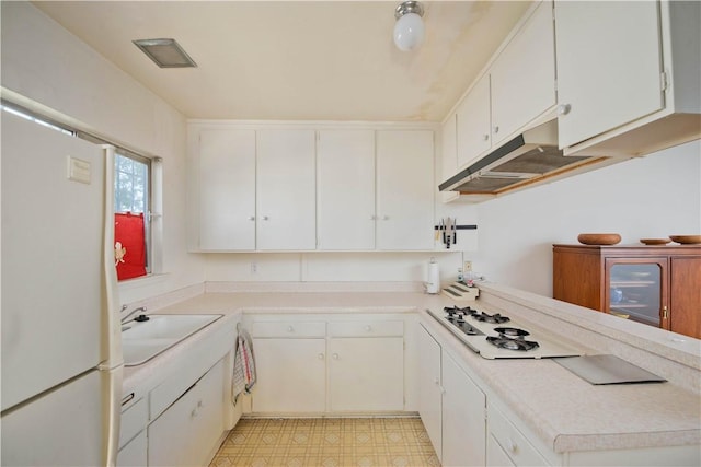 16751 Ludlow St, Granada Hills, CA 91344 - kitchen with a sink, white appliances, light countertops, white cabinetry, and under cabinet range hood