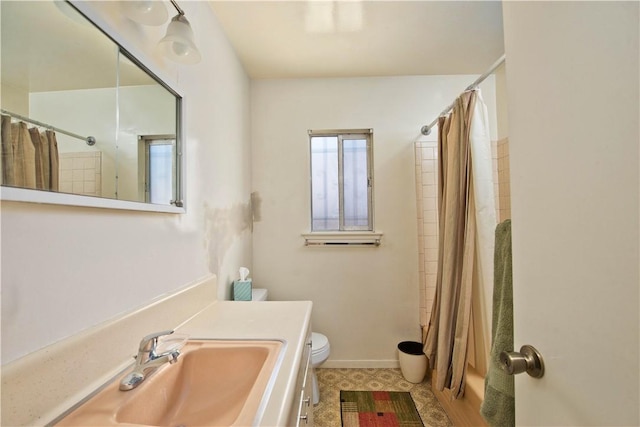16751 Ludlow St, Granada Hills, CA 91344 - bathroom featuring toilet, vanity, shower / tub combo with curtain, and baseboards