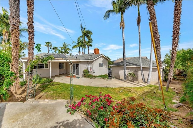 786 S Spanish Oak Ln, La Puente, CA 91746 - rear view of house featuring a lawn, stucco siding, and roof mounted solar panels