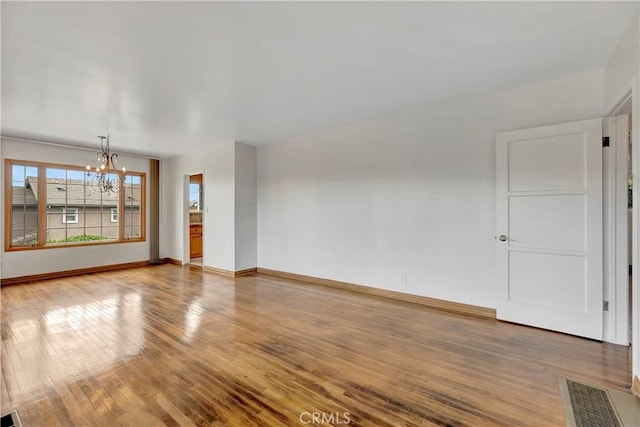786 S Spanish Oak Ln, La Puente, CA 91746 - unfurnished living room with a chandelier, wood finished floors, and baseboards