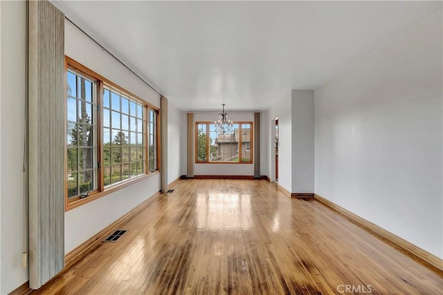 786 S Spanish Oak Ln, La Puente, CA 91746 - empty room featuring a chandelier, baseboards, and light wood-style flooring
