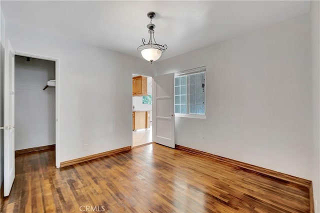 786 S Spanish Oak Ln, La Puente, CA 91746 - unfurnished bedroom with wood finished floors, baseboards, a spacious closet, and a closet
