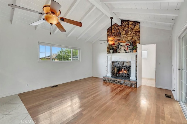 786 S Spanish Oak Ln, La Puente, CA 91746 - unfurnished living room featuring light wood finished floors, a stone fireplace, a ceiling fan, and baseboards