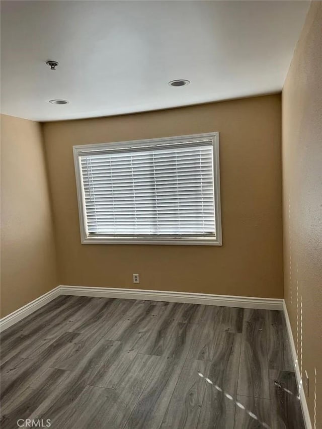 3880 W Jacinto View Rd Unit M, Banning, CA 92220 - spare room featuring wood finished floors, baseboards, a pendent fire sprinkler, and recessed lighting