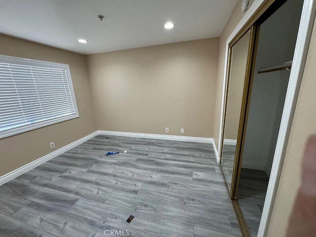 3880 W Jacinto View Rd Unit M, Banning, CA 92220 - unfurnished bedroom featuring a closet, baseboards, wood finished floors, and recessed lighting