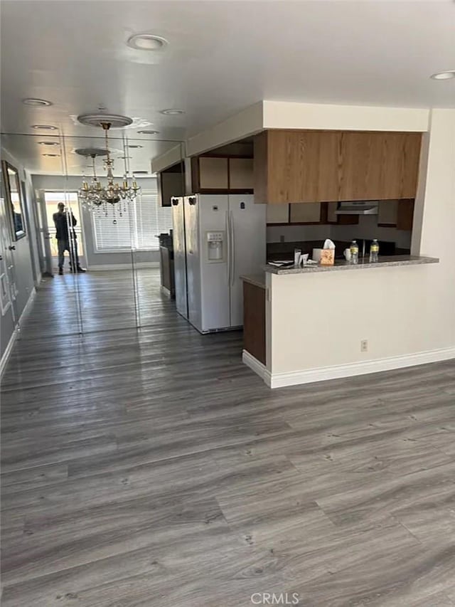 3880 W Jacinto View Rd Unit M, Banning, CA 92220 - kitchen with white fridge with ice dispenser, dark wood-style flooring, brown cabinetry, baseboards, and recessed lighting