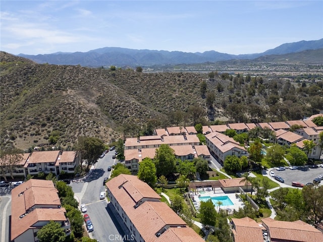 28031 Sarabande Ln Unit 128, Canyon Country, CA 91387 - aerial perspective of suburban area featuring a pool and a mountain backdrop