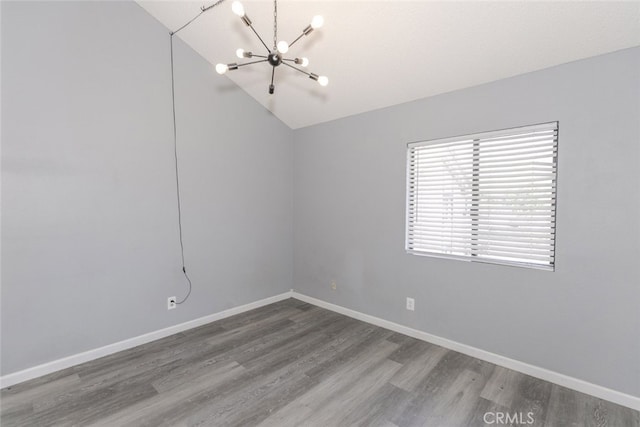 28031 Sarabande Ln Unit 128, Canyon Country, CA 91387 - empty room featuring a chandelier, wood finished floors, vaulted ceiling, and baseboards