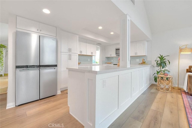 4326 Via Verde, Cypress, CA 90630 - kitchen with stainless steel appliances, light wood-style floors, white cabinetry, recessed lighting, and light countertops