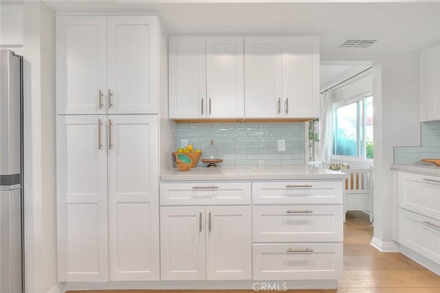 4326 Via Verde, Cypress, CA 90630 - kitchen with white cabinetry, tasteful backsplash, and light countertops