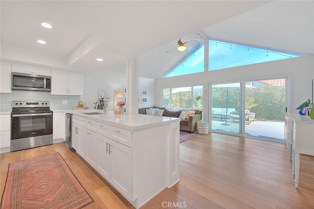 4326 Via Verde, Cypress, CA 90630 - kitchen with appliances with stainless steel finishes, a peninsula, open floor plan, light countertops, and recessed lighting