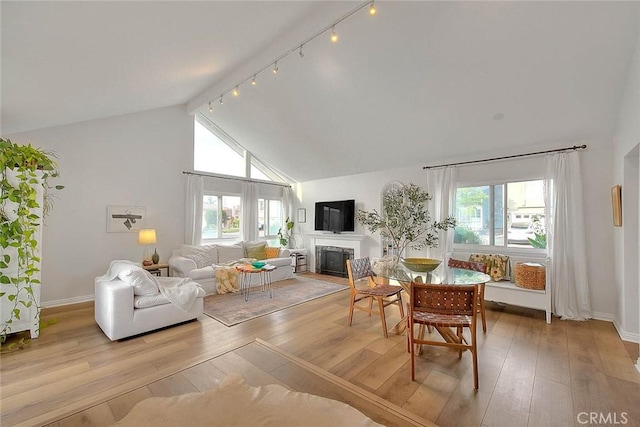 4326 Via Verde, Cypress, CA 90630 - living area featuring hardwood / wood-style flooring, a fireplace, track lighting, and high vaulted ceiling