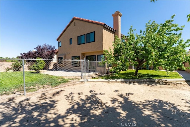 5809 Almond Valley Way, Lancaster, CA 93536 - back of property featuring stucco siding and a chimney