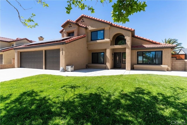 5809 Almond Valley Way, Lancaster, CA 93536 - mediterranean / spanish-style home featuring a garage, roof mounted solar panels, stucco siding, concrete driveway, and a tiled roof