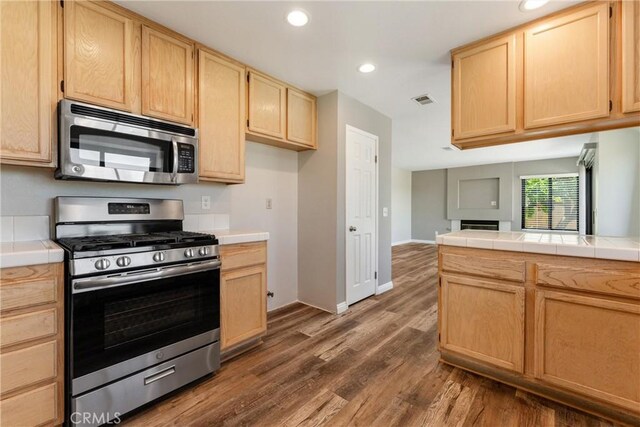 5809 Almond Valley Way, Lancaster, CA 93536 - kitchen with appliances with stainless steel finishes, light brown cabinets, tile countertops, and recessed lighting