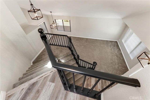 5809 Almond Valley Way, Lancaster, CA 93536 - stairs with wood finished floors and a chandelier