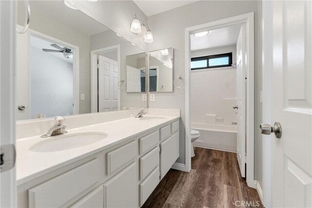 5809 Almond Valley Way, Lancaster, CA 93536 - full bath with toilet, double vanity, wood finished floors, ceiling fan, and bathtub / shower combination