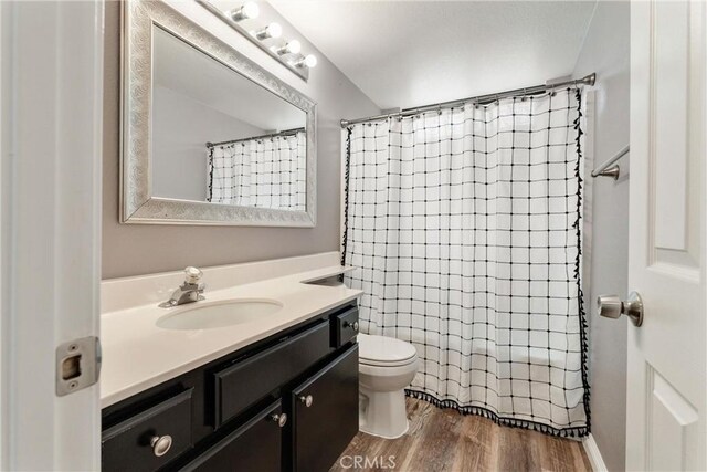 5809 Almond Valley Way, Lancaster, CA 93536 - full bath with vanity, toilet, wood finished floors, and curtained shower