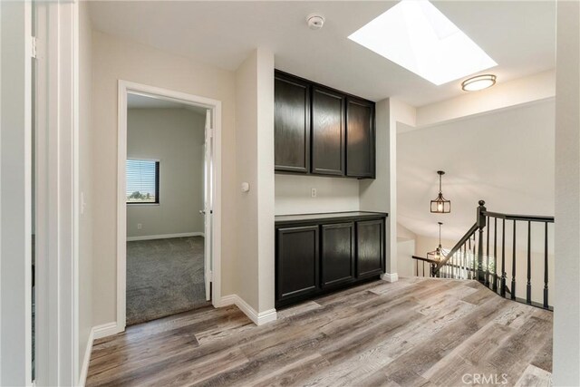 5809 Almond Valley Way, Lancaster, CA 93536 - hall featuring light wood finished floors, a skylight, and baseboards
