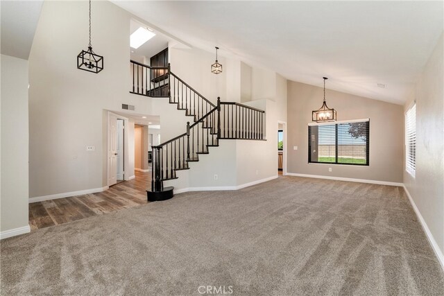 5809 Almond Valley Way, Lancaster, CA 93536 - unfurnished living room featuring carpet, stairs, baseboards, and high vaulted ceiling
