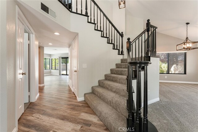 5809 Almond Valley Way, Lancaster, CA 93536 - staircase with baseboards, a chandelier, recessed lighting, wood finished floors, and a high ceiling