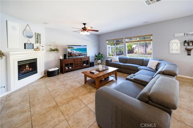 31786 Sorrel Run Ct, Menifee, CA 92584 - living room with light tile patterned floors, a ceiling fan, a glass covered fireplace, and baseboards