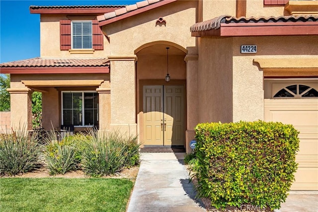 44224 Raven Ln, Lancaster, CA 93536 - entrance to property with a tile roof, stucco siding, and a garage
