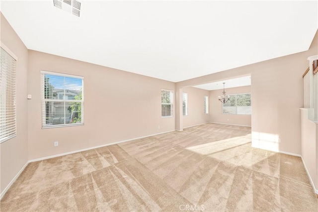 44224 Raven Ln, Lancaster, CA 93536 - carpeted empty room featuring a chandelier, healthy amount of natural light, and baseboards