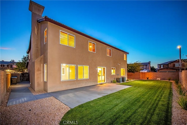 44224 Raven Ln, Lancaster, CA 93536 - back of property featuring stucco siding, a patio, and central AC