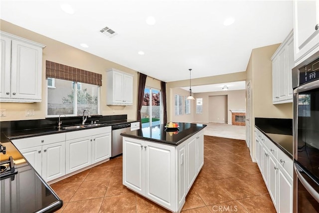 44224 Raven Ln, Lancaster, CA 93536 - kitchen featuring stainless steel dishwasher, a sink, plenty of natural light, dark countertops, and recessed lighting