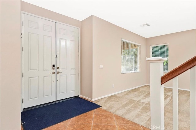 44224 Raven Ln, Lancaster, CA 93536 - tiled foyer entrance featuring carpet floors, baseboards, and stairway