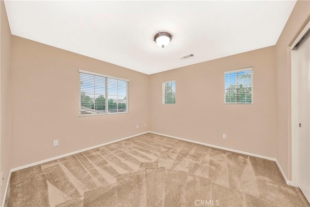 44224 Raven Ln, Lancaster, CA 93536 - empty room with plenty of natural light, baseboards, and carpet