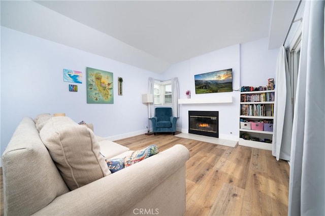 36 Via Lavendera, Rancho Santa Margarita, CA 92688 - living room featuring a fireplace with flush hearth, light wood-type flooring, and baseboards