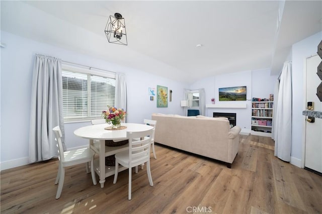 36 Via Lavendera, Rancho Santa Margarita, CA 92688 - dining area featuring light wood-type flooring, a fireplace, and baseboards