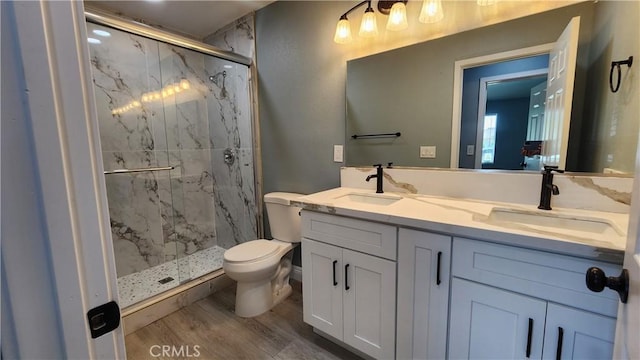 2045 S Cypress Ave, Ontario, CA 91762 - bathroom featuring toilet, a marble finish shower, wood finished floors, and double vanity