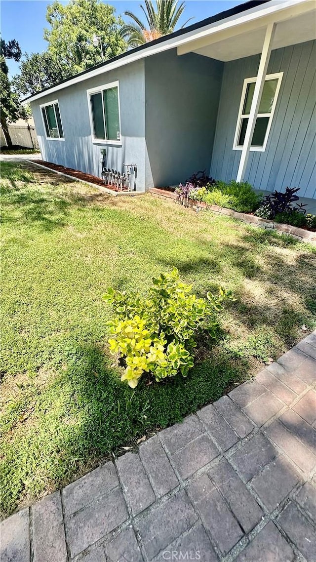 2045 S Cypress Ave, Ontario, CA 91762 - view of property exterior with a lawn and stucco siding