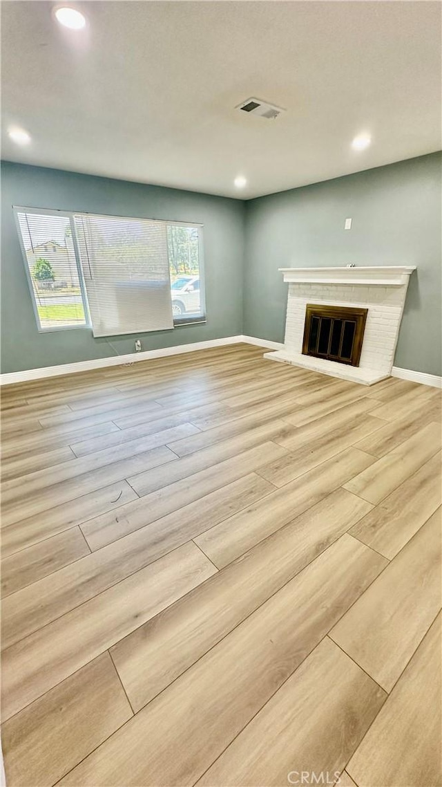 2045 S Cypress Ave, Ontario, CA 91762 - unfurnished living room with wood finished floors, a fireplace, and recessed lighting