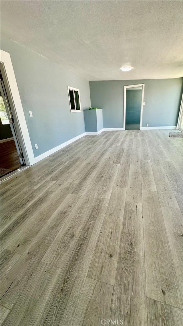 2045 S Cypress Ave, Ontario, CA 91762 - unfurnished room with wood finished floors and a textured ceiling