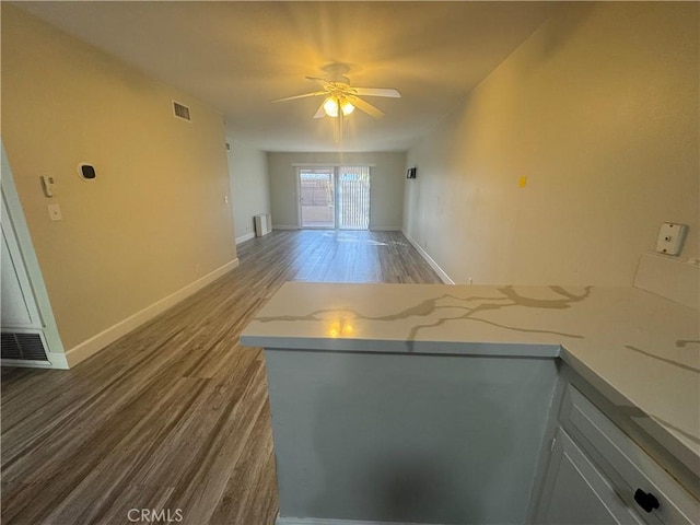 1881 Mitchell Ave Unit 34, Tustin, CA 92780 - unfurnished living room featuring wood finished floors, ceiling fan, and baseboards