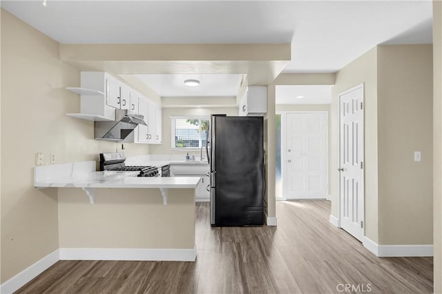 1881 Mitchell Ave Unit 34, Tustin, CA 92780 - kitchen featuring stainless steel appliances, a peninsula, open shelves, dark wood-type flooring, and white cabinetry