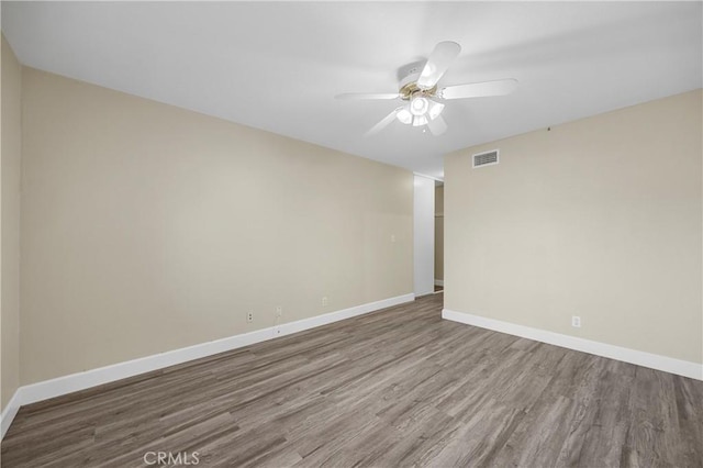 1881 Mitchell Ave Unit 34, Tustin, CA 92780 - spare room featuring wood finished floors, ceiling fan, and baseboards