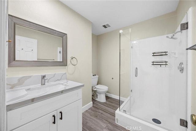 1881 Mitchell Ave Unit 34, Tustin, CA 92780 - full bathroom featuring vanity, a shower stall, wood finished floors, toilet, and baseboards