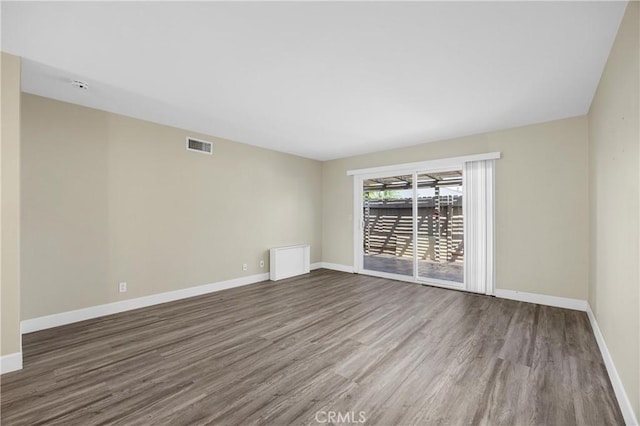 1881 Mitchell Ave Unit 34, Tustin, CA 92780 - spare room featuring wood finished floors, baseboards, and a smoke detector