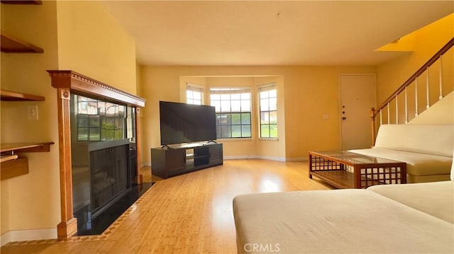 1133 S Paula Dr Unit 7, Fullerton, CA 92833 - living room featuring a fireplace, wood finished floors, baseboards, and stairs
