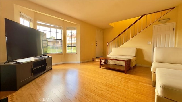 1133 S Paula Dr Unit 7, Fullerton, CA 92833 - living room featuring stairway, light wood finished floors, and baseboards
