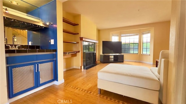 1133 S Paula Dr Unit 7, Fullerton, CA 92833 - living room featuring light wood-style flooring, baseboards, and built in shelves