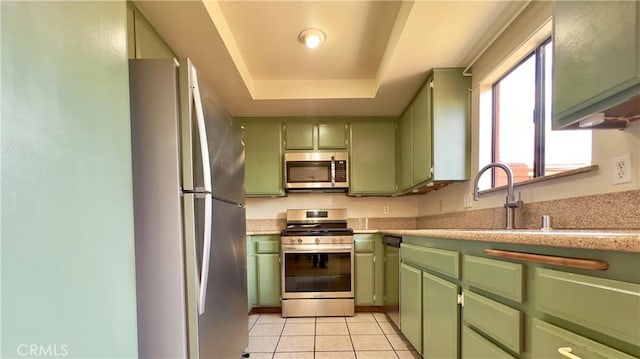 1133 S Paula Dr Unit 7, Fullerton, CA 92833 - kitchen featuring green cabinetry, stainless steel appliances, a raised ceiling, and light countertops